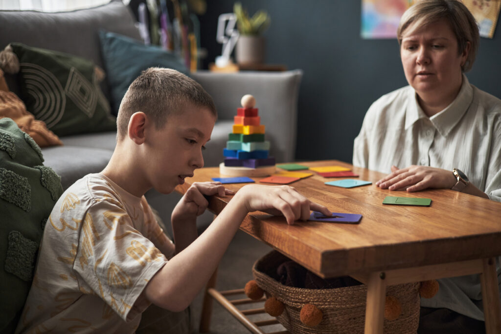 engaging in educational activity at wooden table at home engaging in educational activity at wooden table at home