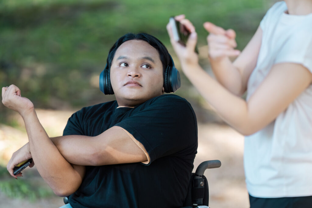 inclusive fitness: friends exercising together outdoors in a park setting with headphones and smartphones inclusive fitness: friends exercising together outdoors in a park setting with headphones and smartphones